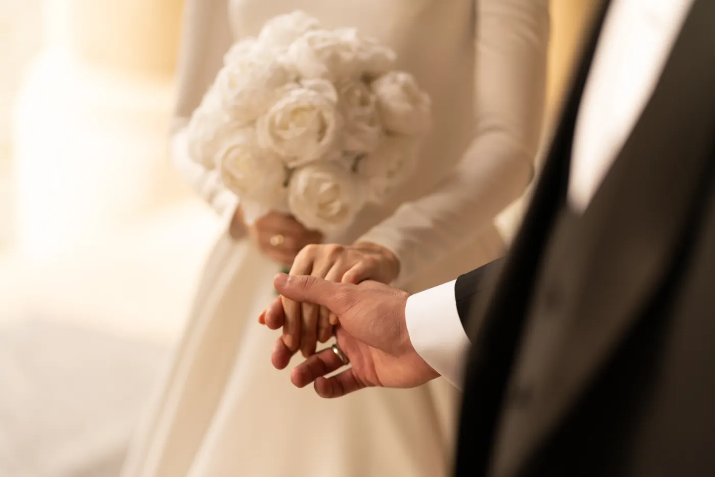 A couple holding hands during their ceremony