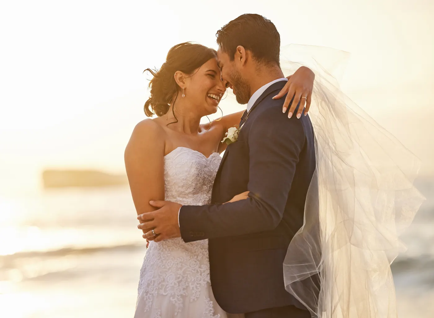 A couple on the beach on their wedding day
