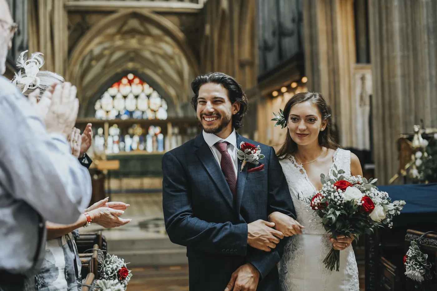 A couple walking back down the aisle after their ceremony